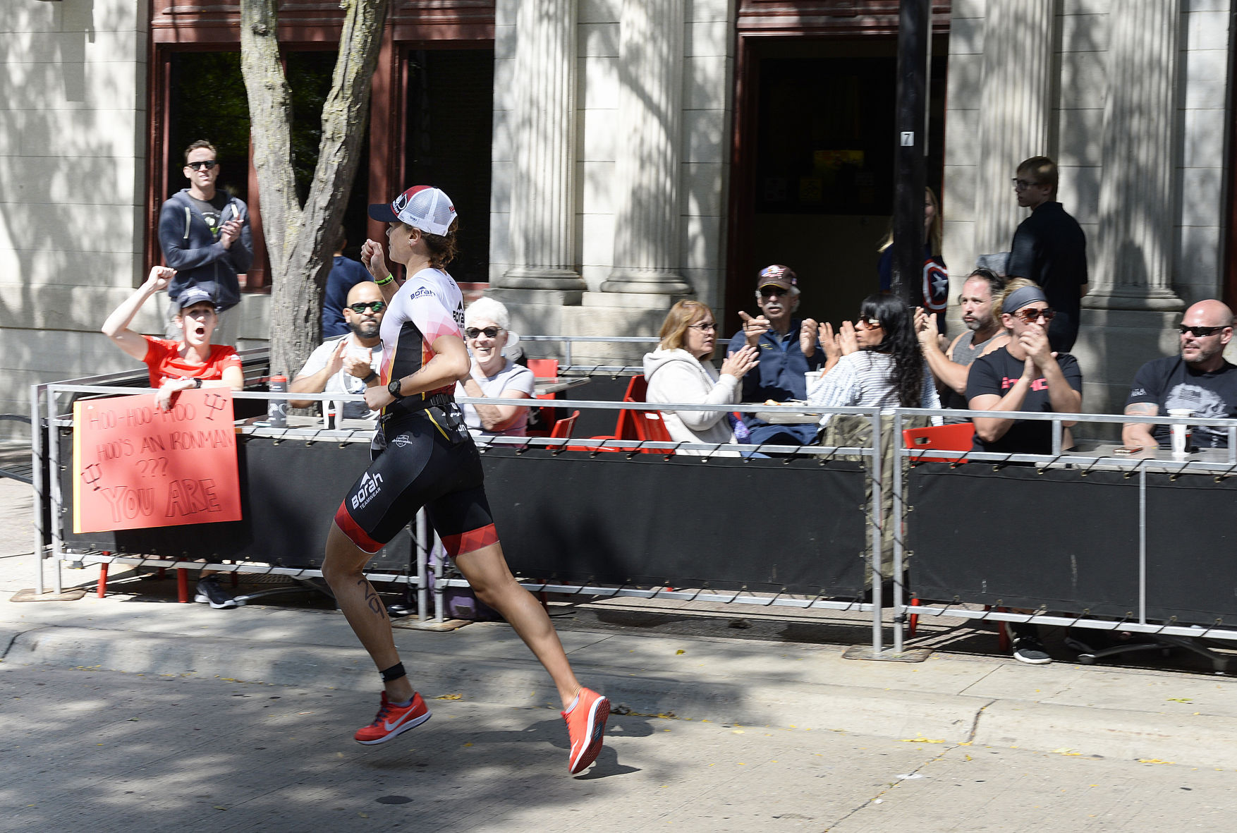 IRONMAN athletes run down State St.